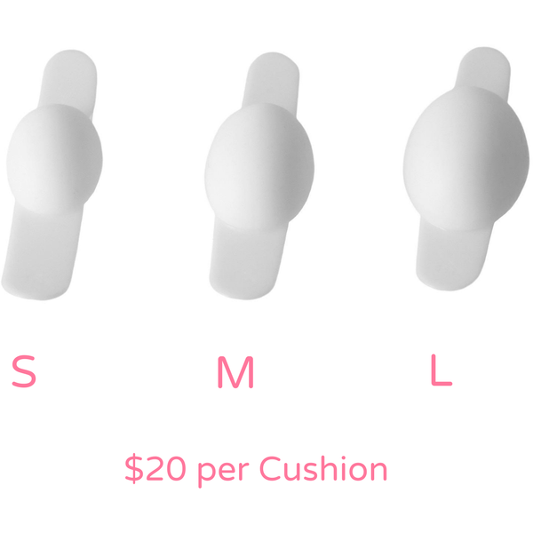 Three white FemiCushion cushion lined small, medium, large from the left with S, M, L pink letters under each size.